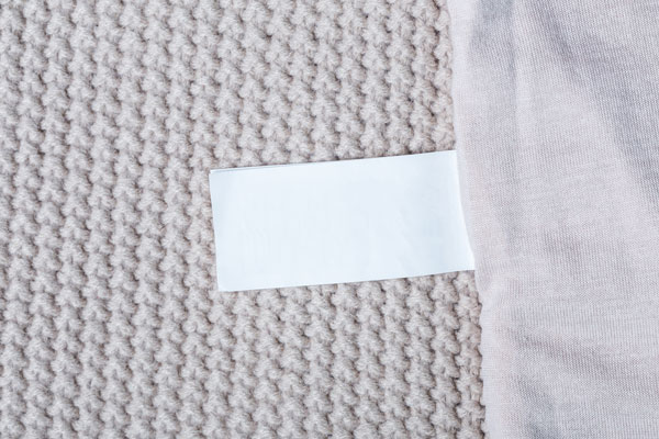 White tag sewn onto a blanket