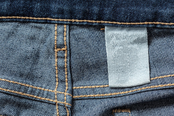 Blank white tag on the inside of blue jeans